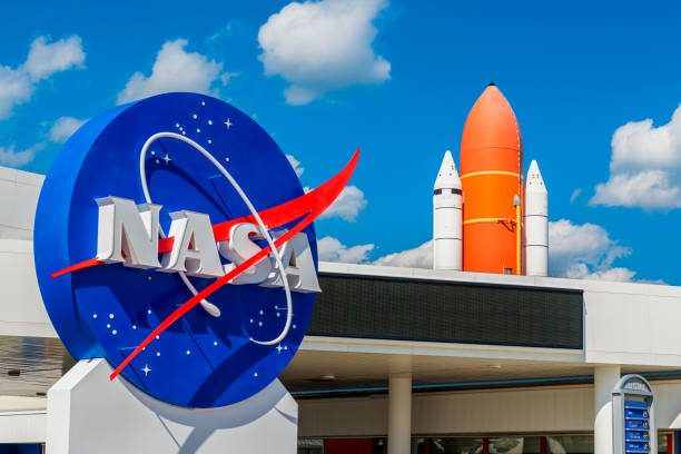 NASA Logo and Atlantis Space Shuttle at Kennedy Space Center Florida Cape Canaveral, FL, USA - April 1, 2015: NASA Logo and Atlantis Space Shuttle at Kennedy Space Center Visitor Complex in Cape Canaveral, Florida, USA. scientific exploration stock pictures, royalty-free photos & images