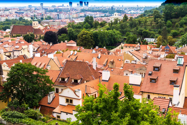 Summer aerial view of the Old Town architecture with red roofs and church of Saint Nicholas in Prague , Czech Republic.
