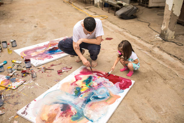 istock Father teaching her daughter to paint 1006722268