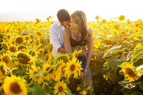 istock Couple enjoying summer time at sunflowers field 1006728754