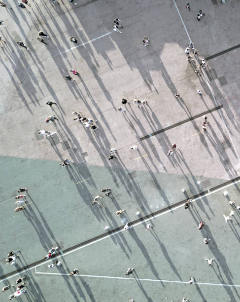 high angle view of people on street - people walking motion city stock-fotos und bilder