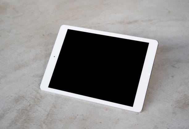 tablet auf zement-boden - tactile tablet computer stock-fotos und bilder
