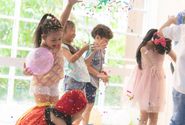 istock Kids are playing and throwing paper in kid party 1006734878