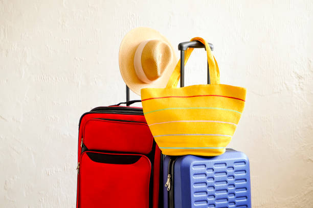 istock Minimalistic composition with suitcase luggage for summer vacation. Travel light concept. 1006738436