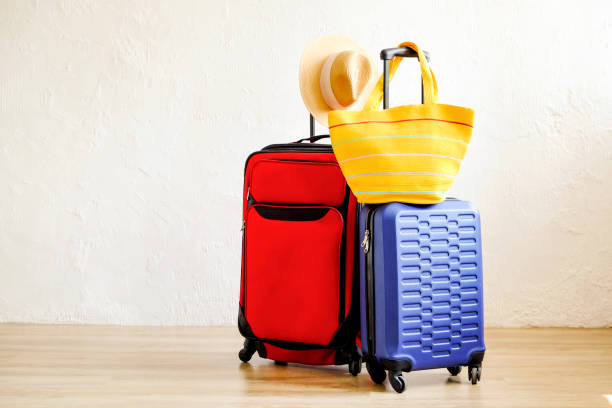 istock Minimalistic composition with suitcase luggage for summer vacation. Travel light concept. 1006738450