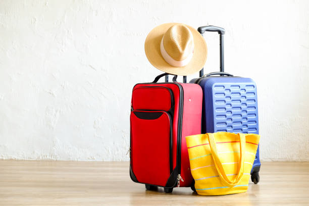 istock Minimalistic composition with suitcase luggage for summer vacation. Travel light concept. 1006738468