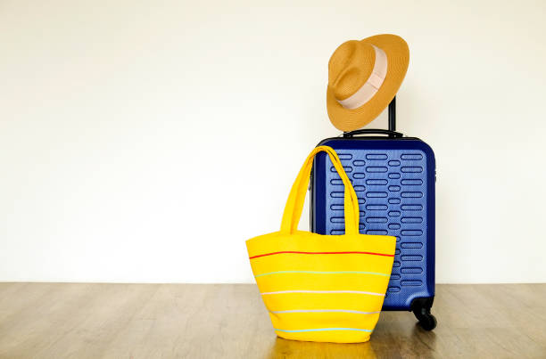 istock Minimalistic composition with suitcase luggage for summer vacation. Travel light concept. 1006738476