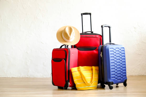 istock Minimalistic composition with suitcase luggage for summer vacation. Travel light concept. 1006738494