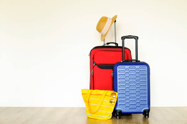 istock Minimalistic composition with suitcase luggage for summer vacation. Travel light concept. 1006738504