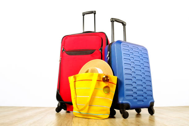 istock Minimalistic composition with suitcase luggage for summer vacation. Travel light concept. 1006738666