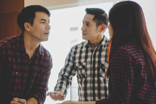 istock Friends trying to stop work couple from fighting each other 1006746758
