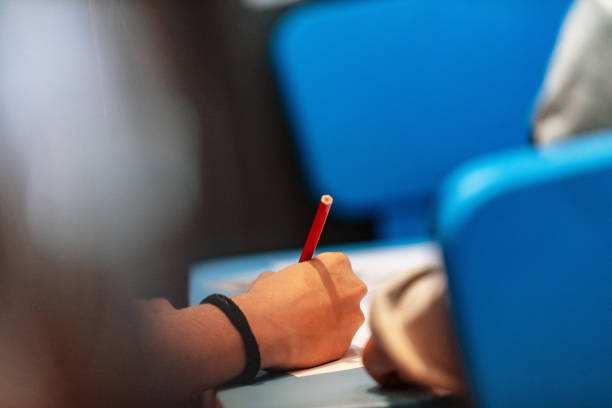 istock Child holding pencil and writing 1006751002