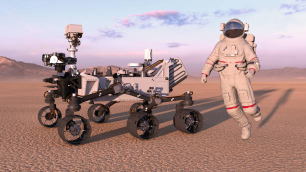 istock Astronaut with mars rover, cosmonaut jumping next to robotic space autonomous vehicle on a deserted planet, 3D render 1006754180