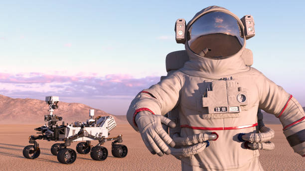 istock Astronaut with mars rover, cosmonaut next to robotic space autonomous vehicle on a deserted planet, close up, 3D render 1006754336