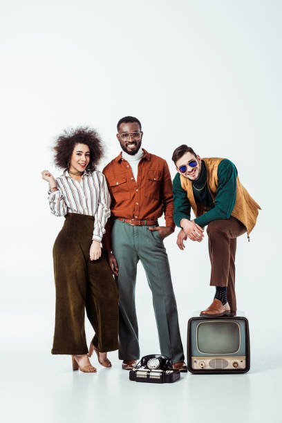 istock smiling multicultural retro styled friends with vintage television looking at camera on white 1006767104