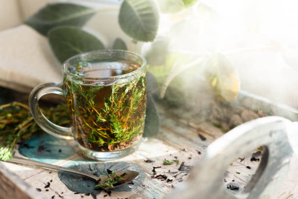 istock Hot herbal tea with bunch of fresh thyme. 1006778164