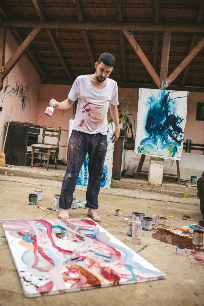 istock Artistic man painting in the backyard 1006778490