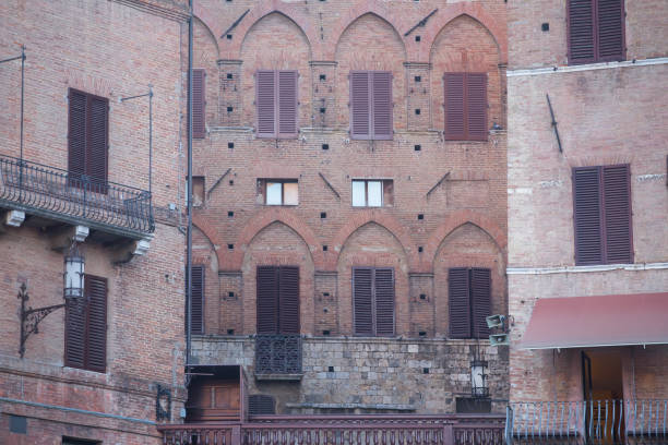 Perugia, Umbria, Italy -- A side view of the Arco Etrusco (Etruscan Gate) in the heart of the Etruscan and medieval city of Perugia in Umbria, central Italy. Founded by the Etruscans on an ancient Umbrian settlement and subsequently conquered by the Romans, Perugia is one of the most loved and visited medieval Italian cities, rich in artistic and architectural treasures that span almost three thousand years of history. The Umbria region, considered the green heart of Italy for its wooded mountains, is characterized by a perfect integration between nature and the presence of man, in a context of environmental sustainability and healthy life. In addition to its immense artistic and historical heritage, Umbria is famous for its food and wine production and for the high quality of the extra virgin olive oil produced in these lands. Image in high quality format.