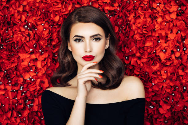 istock Portrait of a beautiful woman standing against floral pattern 1006810708
