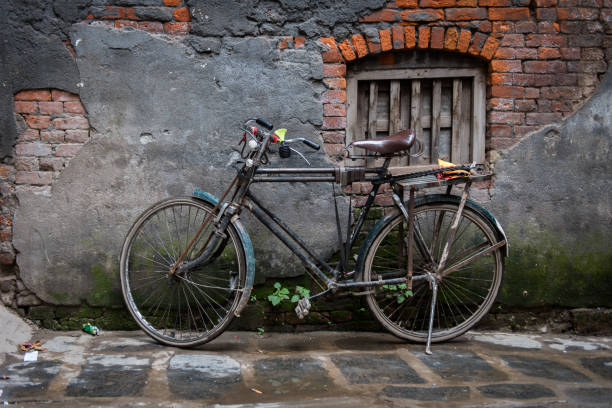 istock Old bicycle stood near a decaying wall 1006817010