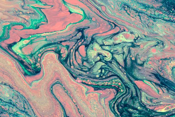 Creative abstract marbling textured background. Mixing red, green and blue paints. Handmade surface. Liquid paint.