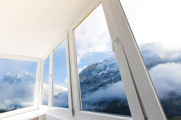 istock White metal-plastic windows of balcony in modern apartment panoramic view mountains 1006833134