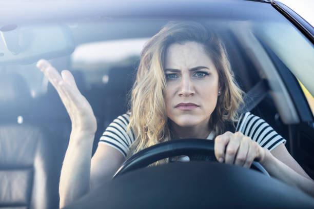 istock Angry woman driving a car 1006837910