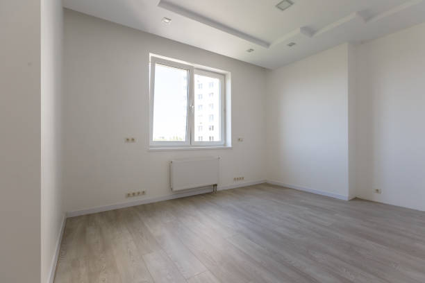 istock Empty white room with wooden parquet floor after renovation 1006837922