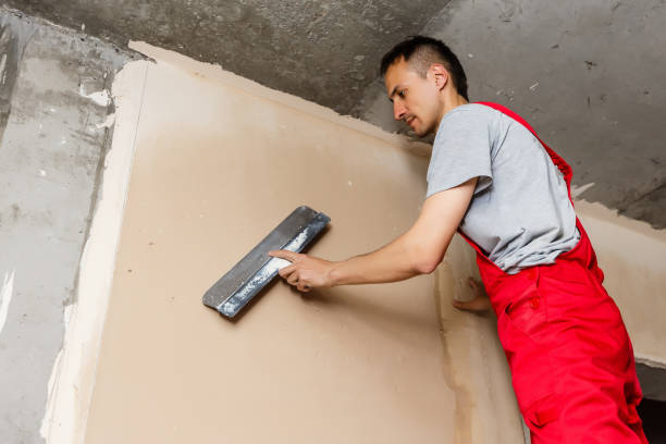 istock Mason plastering the concrete to build wall, Construction under building with mason plastering concrete to brick wall 1006838366
