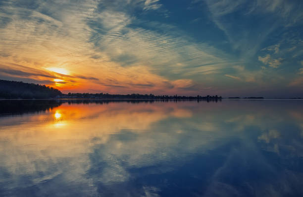 istock Beautiful clouds and colorful water in lake reflected in evening 1006864818