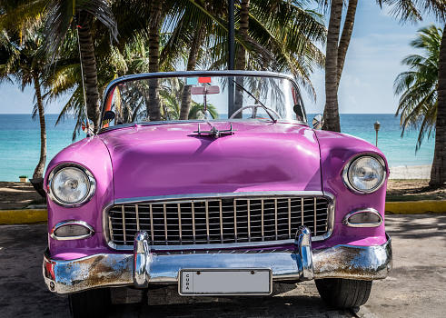 American pink classic convertible car in the front view on the beach in Varadero Cuba - Serie Cuba Reportage