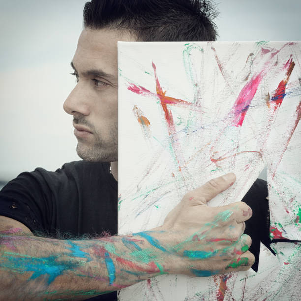 istock Close-Up Of Man Tearing Canvas 1006867890