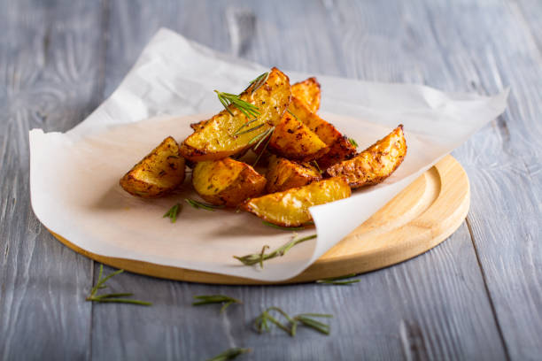 grilled potatoes rosemary wooden background