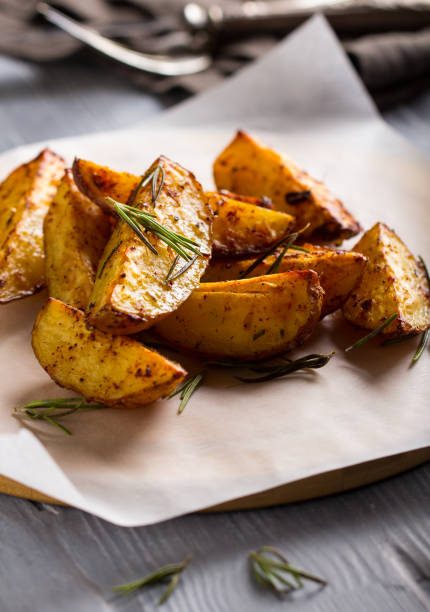 grilled potatoes rosemary wooden background