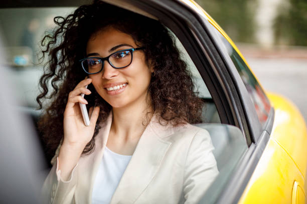 istock Businesswoman using smart phone while commuting to work by taxi 1006875738
