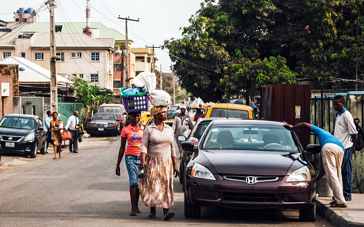 Lagos, Nigeria - February 29, 2016: Street scene with local people in residential area of African megacity.