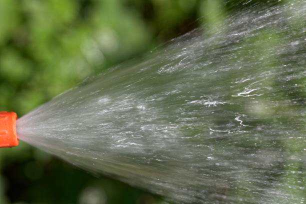 istock Water jet from a hosepipe with a green background 1006891570