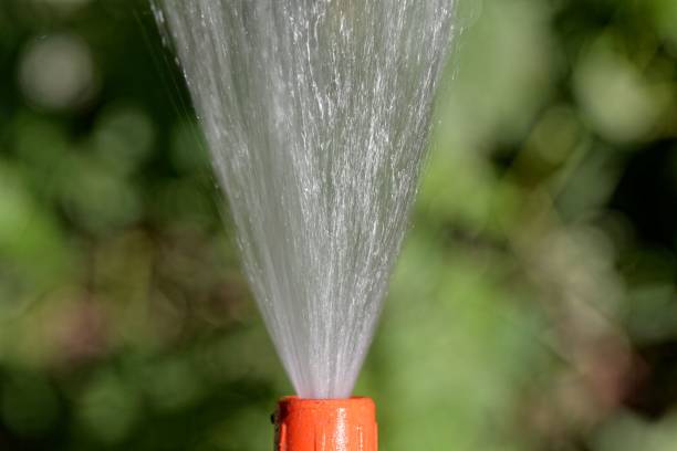 istock Water jet from a hosepipe with a green background 1006891696