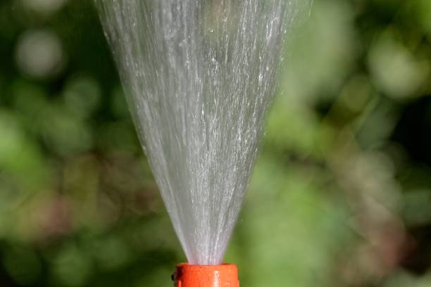 istock Water jet from a hosepipe with a green background 1006891742
