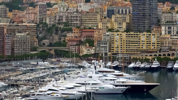 Luxury life in Monaco, view on expensive white yachts and modern apartments