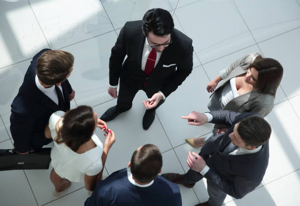 istock top view. employees standing in a modern office 1006904088
