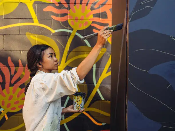 Photo of Mural artist at work