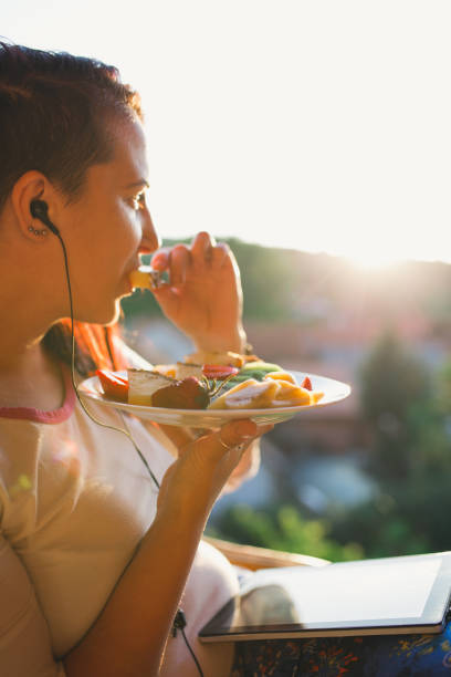 istock Young woman having healthy dinner 1006917320