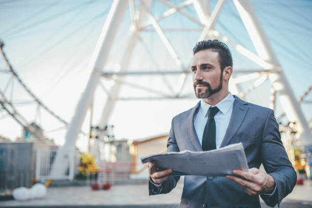 istock Businessman reading newspaper 1006940124
