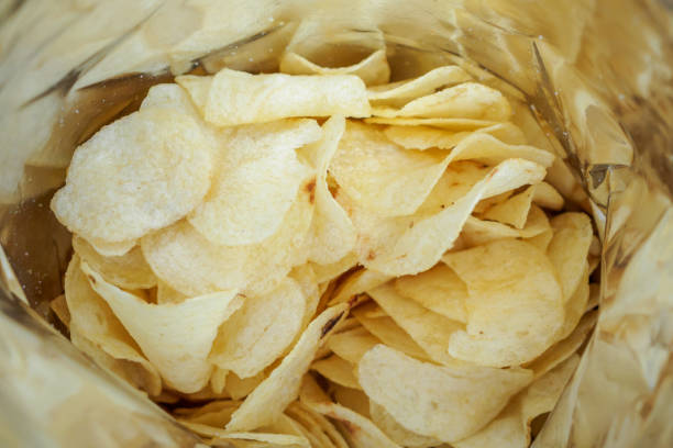 istock Potato chips in open snack bag close up 1006940840