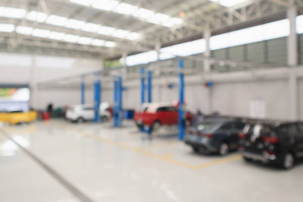 istock car service centre with auto at repair station bokeh light defocused blur background 1006940934