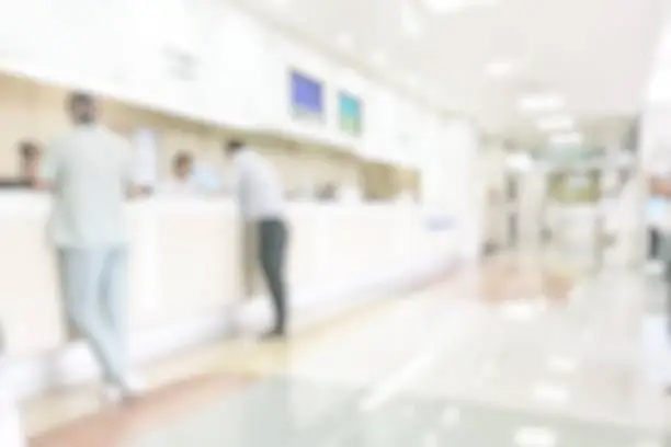 Photo of Medical blur background customer reception or patient service counter, office lobby in hospital clinic, or bank business building blurry interior inside waiting hall area