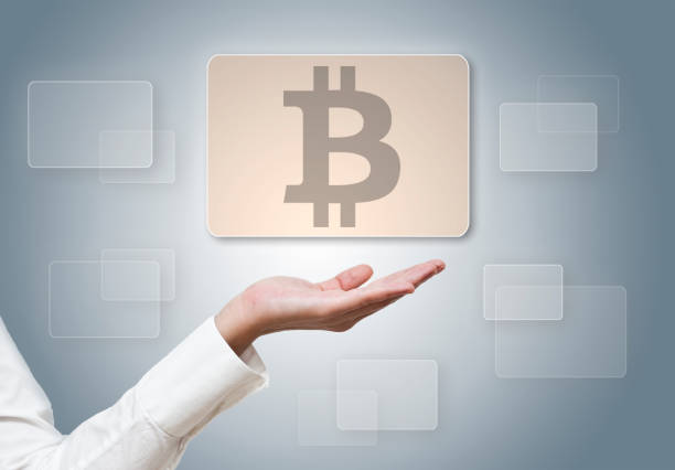 istock Businesswoman holding panel with BITCOIN LOGO / SIGN (Click for more) 1006968534