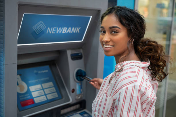 istock Woman withdrawing money on an ATM 1006969018