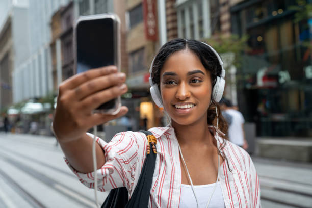 istock Woman outdoors making a video conference on her phone 1006969028